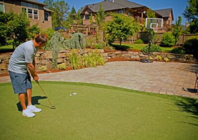 86 Res Outdoor Entertaining Space with Pavers Synthetic Turf and Natural Boulder Walls